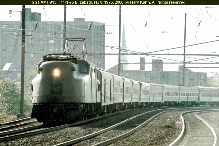 (370k, 900x598)<br><b>Country:</b> United States<br><b>City:</b> Elizabeth, NJ<br><b>System:</b> Northeast Corridor (NJ) (Amtrak/NJTransit)<br><b>Line:</b> Northeast Corridor<br><b>Location:</b> Elizabeth<br><b>Car:</b> PRR/Amtrak GG1 913 <br><b>Photo by:</b> Harv Kahn<br><b>Date:</b> 11/1/1975<br><b>Viewed (this week/total):</b> 1 / 2625