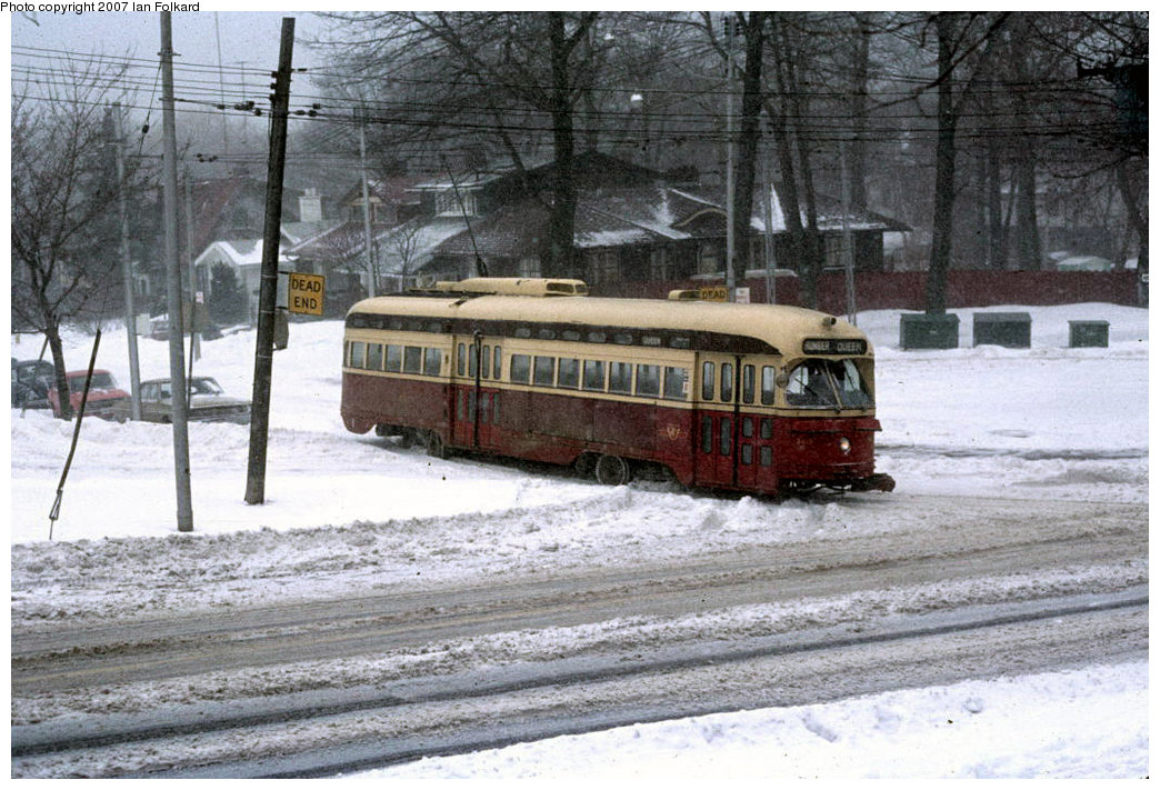 (240k, 1044x711)<br><b>Country:</b> Canada<br><b>City:</b> Toronto<br><b>System:</b> TTC<br><b>Line:</b> TTC 501-Queen<br><b>Location:</b> Queen/Neville Park Loop<br><b>Car:</b> PCC (TTC Toronto) 4415 <br><b>Photo by:</b> Ian Folkard<br><b>Date:</b> 12/1975<br><b>Notes:</b> 4415 leaving Neville Park Loop, Dec 1975.  <br><b>Viewed (this week/total):</b> 0 / 2465